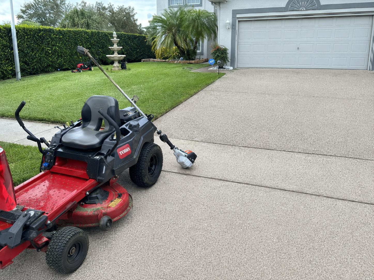 Lawn mowing with a Toro mower on a tidy lawn